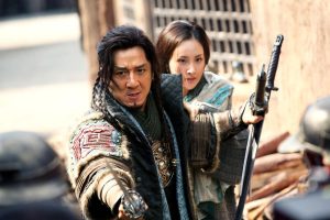 Xin Qing (Mika Wang), back, and Huo An (Jackie Chan) in DRAGON BLADE. Photo credit: Lionsgate Premiere, press site